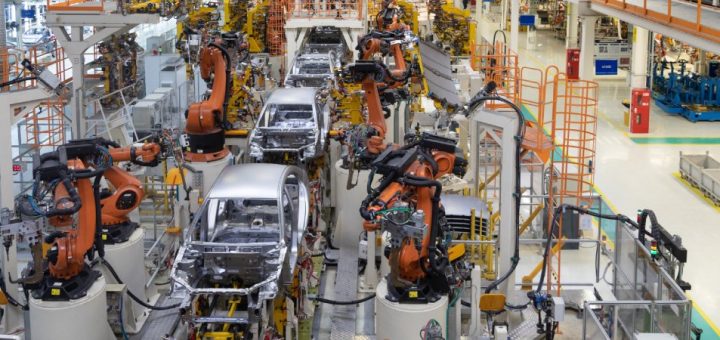 A modern high-tech manufacturing facility for automotive assembly lines with robotic arms assembling car frames.