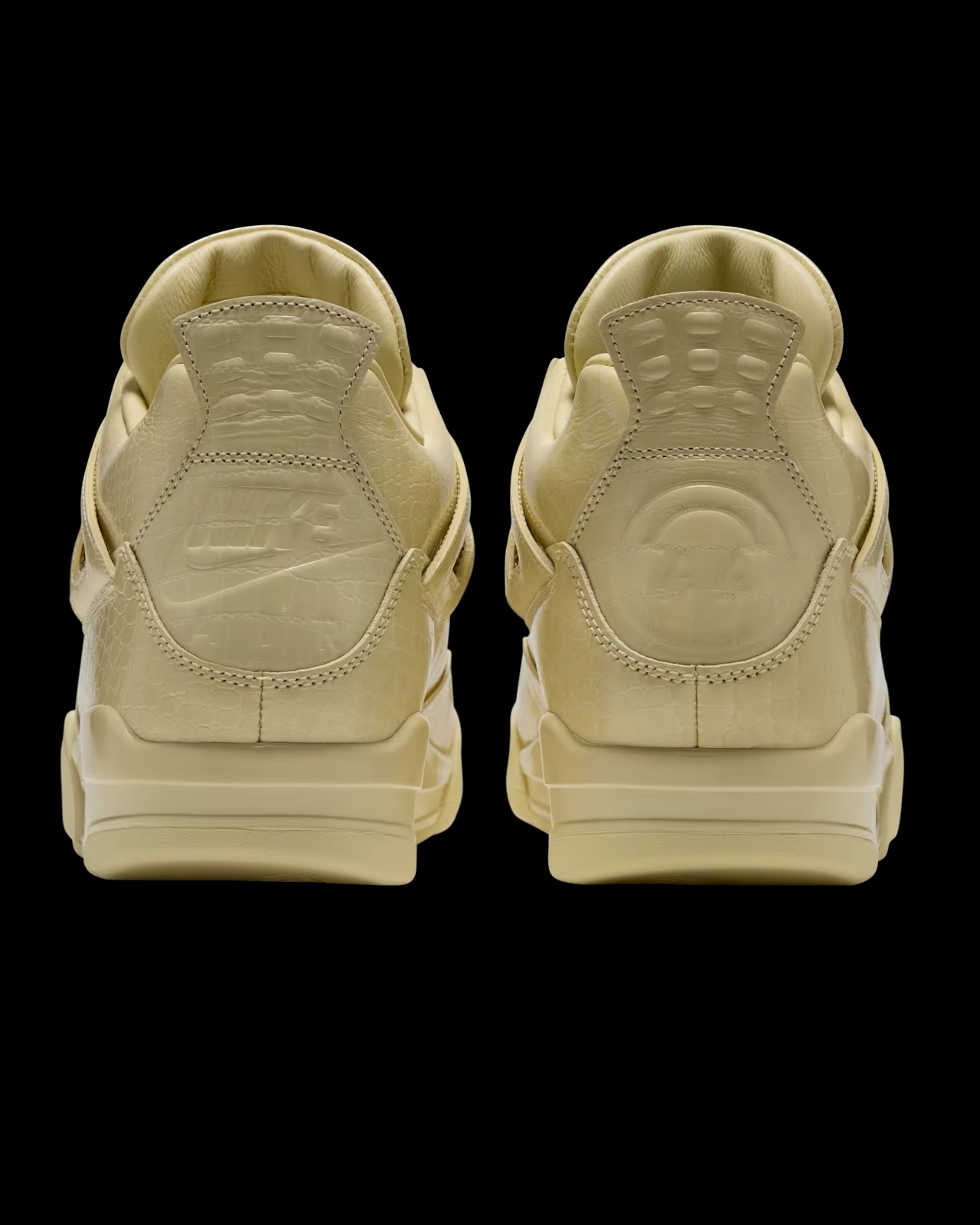 Rear view of Air Jordan 4 x J Balvin sneaker pair showing heel tab detail