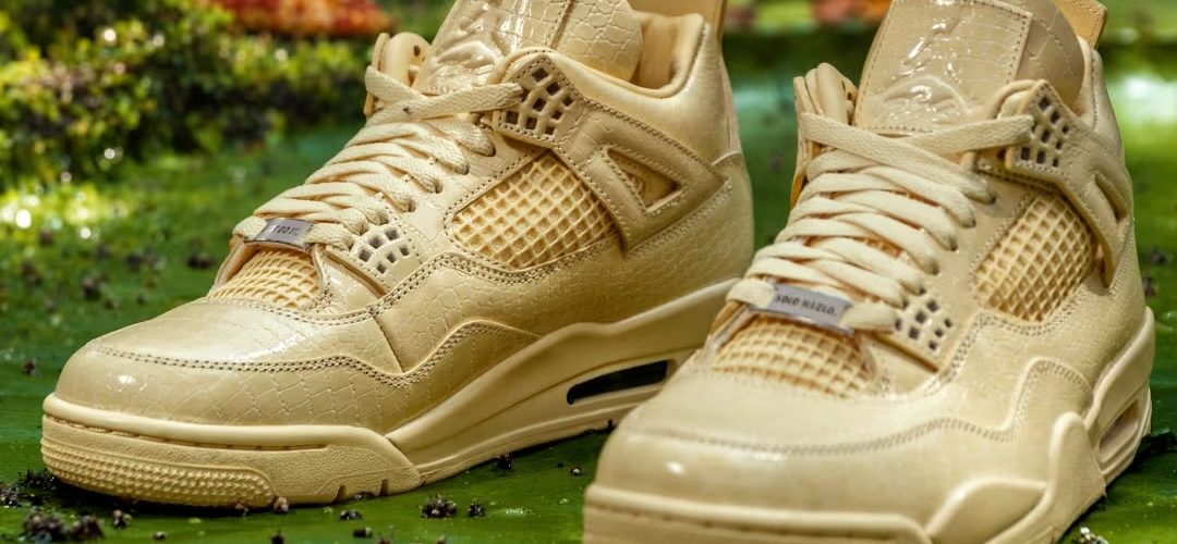 Pair of Air Jordan 4 x J Balvin sneakers toe-to-toe on a leafy green backdrop